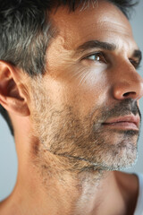 Obraz premium A middle-aged American man with blue eyes, focusing on skincare, close-up portrait