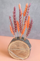 Handmade interior decor. Wheat as a symbol of Ukraine and life. Colored dry flowers. Painted spikes...
