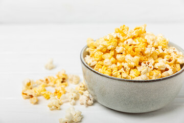 Tasty popcorn on wooden background. Cinema and entertainment concept. Movie night with popcorn.Cheese and caramel popcorn. Delicious appetizer, snack. Place for text. Copy space.Banner