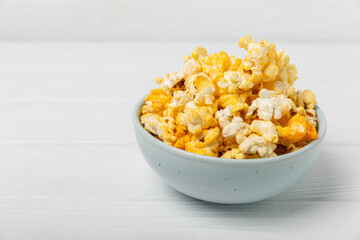 Tasty popcorn on wooden background. Cinema and entertainment concept. Movie night with popcorn.Cheese and caramel popcorn. Delicious appetizer, snack. Place for text. Copy space.Banner