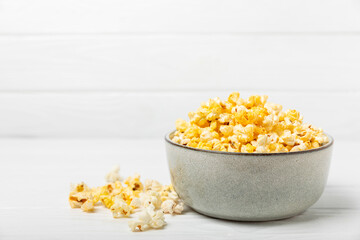 Tasty popcorn on wooden background. Cinema and entertainment concept. Movie night with popcorn.Cheese and caramel popcorn. Delicious appetizer, snack. Place for text. Copy space.Banner
