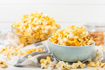 Tasty popcorn on wooden background. Cinema and entertainment concept. Movie night with popcorn.Cheese and caramel popcorn. Delicious appetizer, snack. Place for text. Copy space.Banner