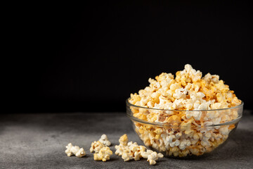 Tasty popcorn on wooden background. Cinema and entertainment concept. Movie night with...
