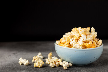 Tasty popcorn on wooden background. Cinema and entertainment concept. Movie night with...
