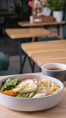 A bowl of couscous, meat, eggs and avocado with cup of coffee. Breakfast concept