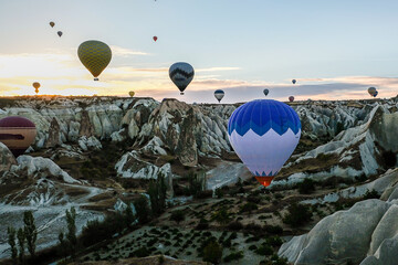 CAPPADOCIA, TURKEY - Hot air balloon flying over rock landscape at Cappadocia Turkey