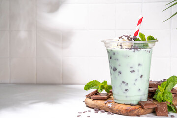Milky mint chocolate chips shake cocktail. Sweet tasty chocolate cookie and mint milkshake garnished with mint leaves, chocolate shavings, whipped cream