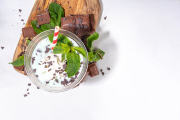 Milky mint chocolate chips shake cocktail. Sweet tasty chocolate cookie and mint milkshake garnished with mint leaves, chocolate shavings, whipped cream