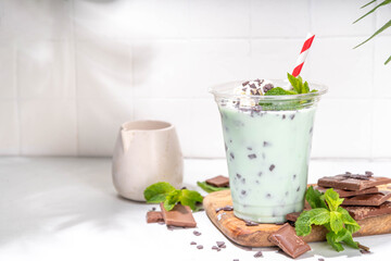 Milky mint chocolate chips shake cocktail. Sweet tasty chocolate cookie and mint milkshake garnished with mint leaves, chocolate shavings, whipped cream