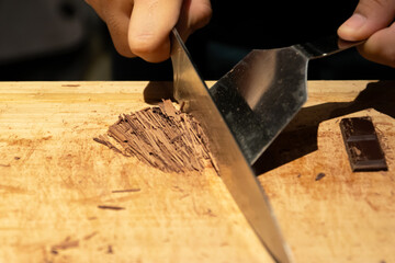 Close up of a chef crafting chocolate for drink and dessert.