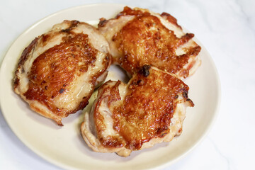 Roasted chicken leg with spice, ready to served on dish.