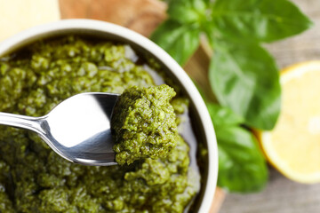 Taking tasty pesto sauce at table, top view