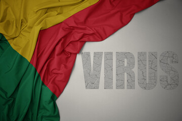 waving colorful national flag of benin on a gray background with text virus .