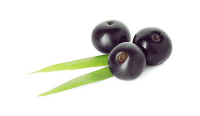Fresh ripe acai berries and green leaves isolated on white
