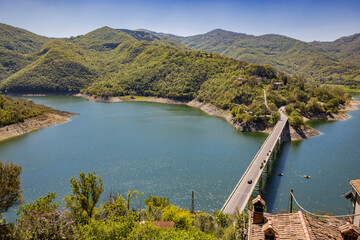 A view of Lake Turano, from the village of Castel di Tora, Rieti, Lazio, Italy. The bridge crossing...