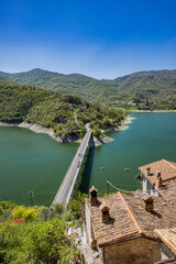 A view of Lake Turano, from the village of Castel di Tora, Rieti, Lazio, Italy. The bridge crossing...