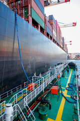Ship refueling operation in port.