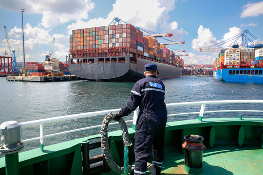 Ship refueling operation in port.