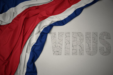 waving colorful national flag of on a gray background with text virus .