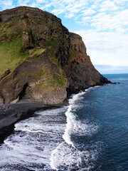 Fototapeta premium Aerial view of Reynisfjara black sand beach and sea stacks in Iceland.