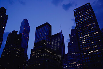 a city skyline with the sun setting behind it