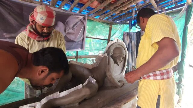 Sculptor Artist Making Plaster Of Paris Mold of a Dying warrior clay Sculpture. This sculpture representing the Trojan king Laomedon, belongs to the pediment of the Aphaia Temple in the small island o