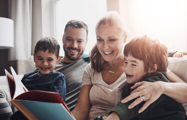 Parents, kids and books for reading on couch, literature and fairytale for storytelling and bonding in home. Children, family and fiction in living room for knowledge, learning and literacy growth