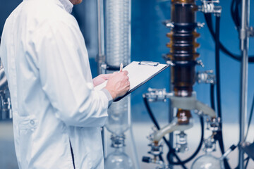 medicine science factory staff worker check quality products sterilize in autoclave tank in check...