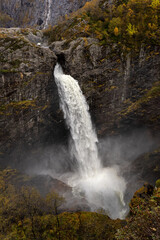 Breathtaking aerial view on the huge waterfall and the valley around it. Bird eye view and rainbow next to the waterfall. Norway, Manafossen.