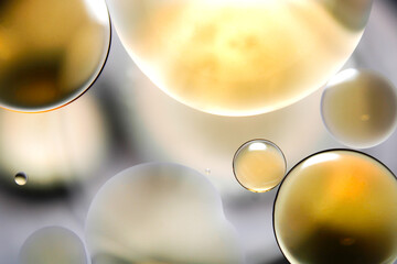 Close-up of oil droplets floating on water.