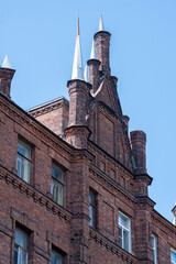 Obraz premium Detail of an old brick building in neo-Gothic style in the city
