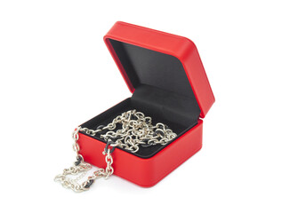 Red gift case with silver necklace on white background