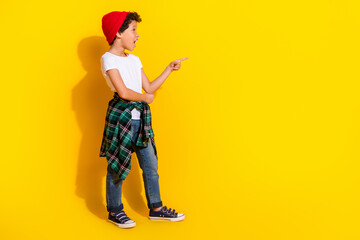 Full size photo of small charming boy point look amazed empty space wear trendy white outfit...
