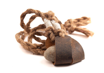 Antique Sling Shot and Stones on a White Background from the Story of David and Goliath in the Bible