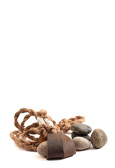 Antique Sling Shot and Stones on a White Background from the Story of David and Goliath in the Bible