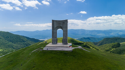 Monument arch of freedom on the top of shipka peak in bulgaria, standing tall against a cloudy sky