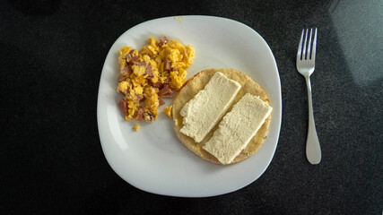typical Colombian breakfast: eggs and arepa