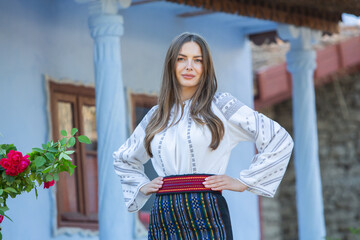 Beautiful girl in traditional Romanian folk costume with embroidery. Woman traditional blouse....