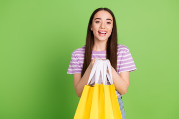 Photo portrait of pretty young girl hold shopping bags wear trendy striped violet outfit isolated...