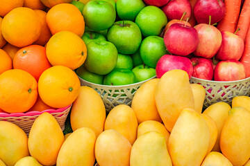 fruits and vegetables, mangoes, oranges, apples at the grocery market