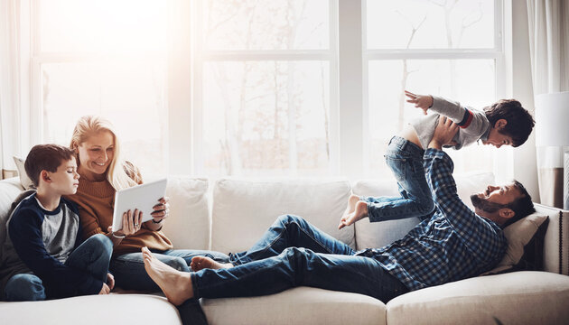 Family, kids and happy on sofa, playful and tablet with plane game, love and streaming on app in living room. Mother, father and children for movies, flight and connection to relax on couch in home