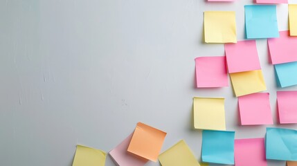 Bright sticky notes on textured white wall with ample space for text. Suitable for business planning, office organization, or creative brainstorming themes