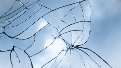 background with shattered broken glass window or mirror reflecting the blue sky