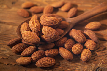 Almond in Wooden Spoon on a Rustic Table. Food Concept of Healthy Eating. Delicious Roasted Almond Nut, Vegan Food