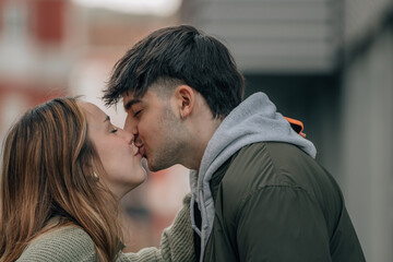 young couple kissing on street, love