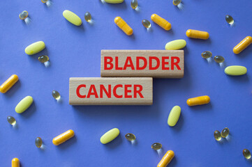 Bladder Cancer symbol. Concept word Bladder Cancer on wooden blocks. Beautiful purple background with pills. Medicine and Bladder Cancer concept. Copy space