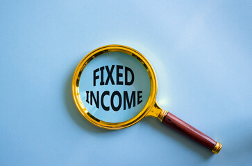 Fixed Income symbol. Concept word Fixed Income on magnifying glass. Beautiful blue background. Business and Fixed Income concept. Copy space