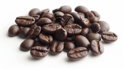Naklejka premium Small pile of whole coffee beans scattered on a smooth white surface