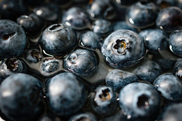 Blueberries in water. Berries. Close-up. Wallpaper and background. Geometry