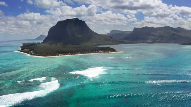 Turquoise clean lagoons protected by coral reefs of Le Morne peninsula with basalt mount on Mauritius island. Also a wonderful kiteboarding and windsurfing spot. Exotic traveling aerial 4K video.